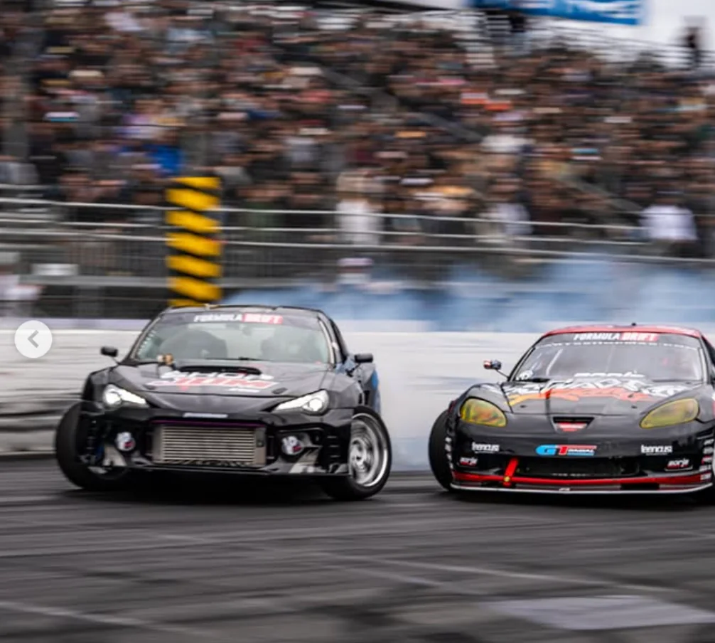 Diego Higa's drift car competing door to door during Formula Drift