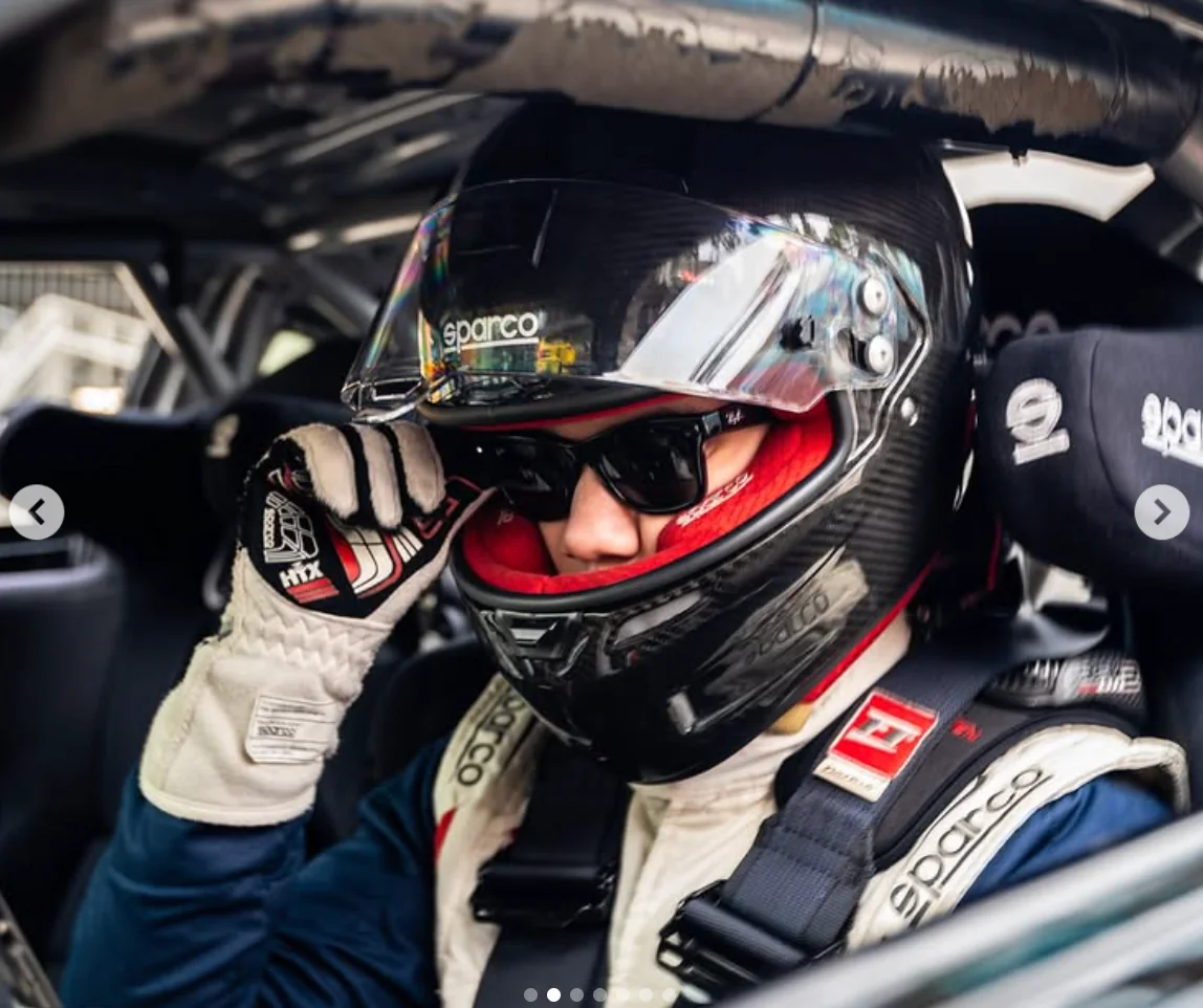 Diego Higa in a racing helmet preparing to drive